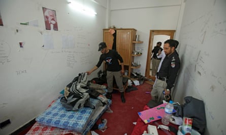 Police search the dorm room of Mashal Khan.
