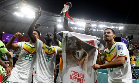 Kalidou Koulibaly (second left) and his Senegal teammates hold up a poster in tribute to Papa Bouba Diop, who died two years ago.