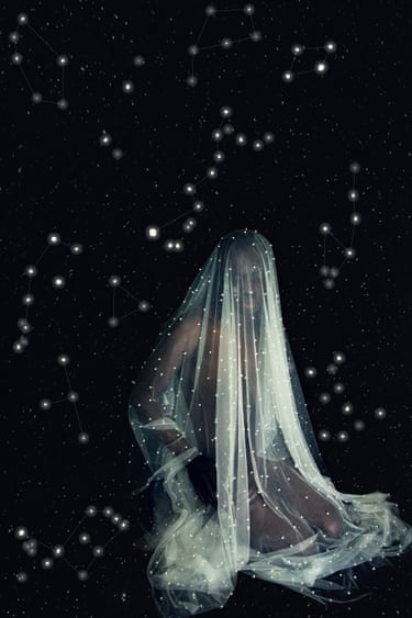 A person draped in sheer veiled fabric sits amid a starry sky