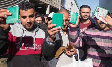 Sodastream employees show their Palestinian identity cards.