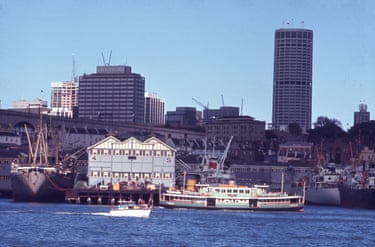 An archival photograph shows the The Lady Denman ferry passing the Walsh Bay wharves
