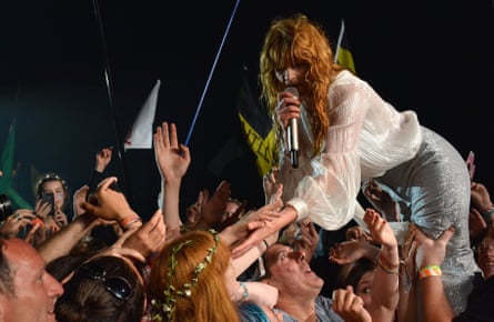 Florence Welch reaching into the crowd from the Pyramid stage during the first day of the 2015Glastonbury festival