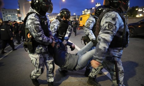 Riot police detain a demonstrator during a protest against mobilisation in Moscow, Russia