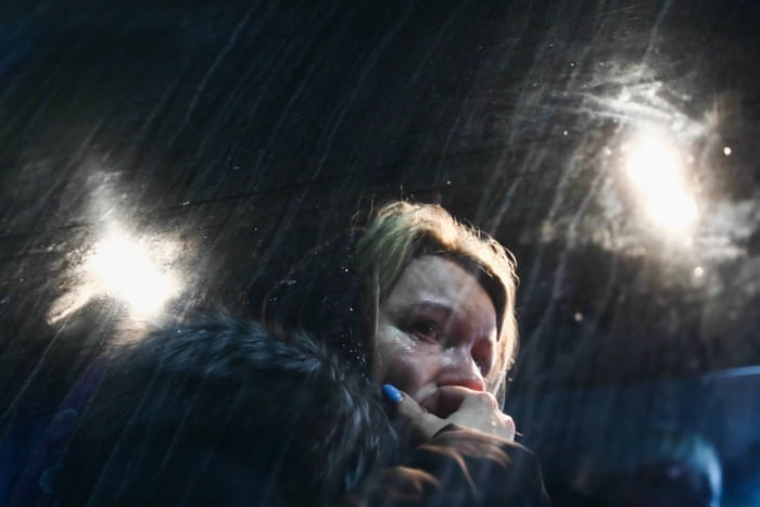 A woman fleeing from Ukraine arrives by bus to a parking lot in Przemysl, Poland on 2 March.
