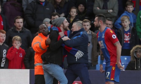 A Crystal Palace fan tries to attack Damien Delaney with Crystal Palace losing 4-0 at half-time in their humiliating home defeat to bottom-placed Sunderland.
