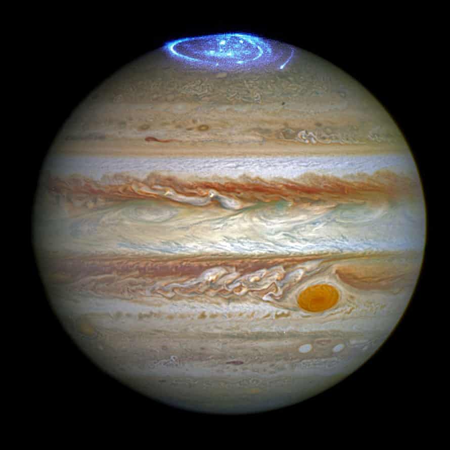 Jupiter appearing to be wearing a luminous crown in this Hubble Space Telescope image showing an aurora over one of the planet’s poles.