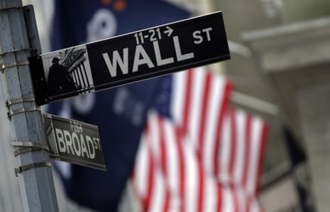 FILE - This Oct. 2, 2014 file photo shows a Wall Street sign adjacent to the New York Stock Exchange, in New York. European shares shed earlier gains Thursday, Dec. 3, 2015 after the European Central Bank failed to cut a key interest rate as much as many in the markets had expected. (AP Photo/Richard Drew, File)