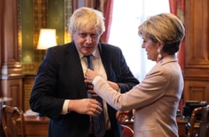 Johnson, foreign secretary, has his tie straightened by his Australian counterpart Julie Bishop in the Foreign and Commonwealth office in Westminster in 2017