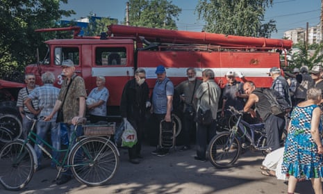 People queue to collect humanitarian aid in Lisichansk, Luhansk Oblast, Ukraine, on June 8, 2022.
