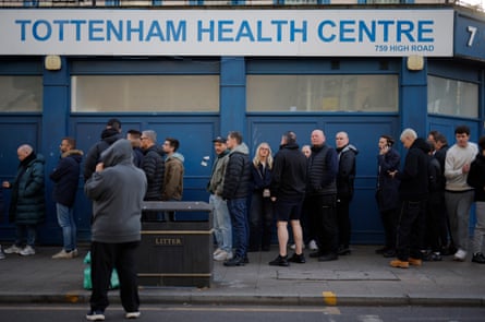 Fans queueing for a cafe in front of the Tottenham Health Centre opposite the stadium