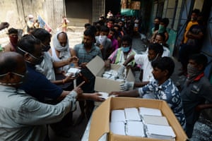 Chennai , India: volunteers distribute food to migrant workers during the first day of a 21-day government-imposed nationwide lockdown