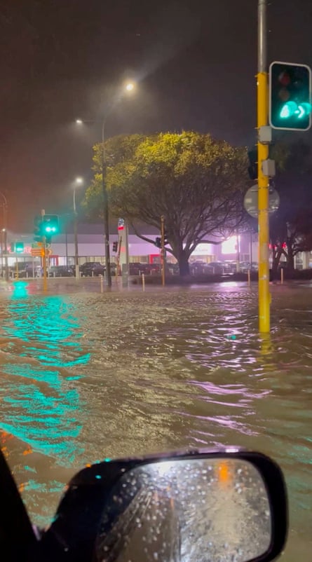 A vehicle drives through a flooded road in Wellington, New Zealand