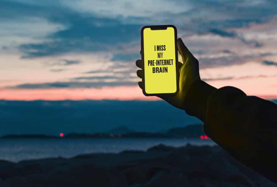 Picture of a person holding a mobile phone with the message on it saying "I miss my pre-internet brain" from Douglas Coupland's series Slogans for the 21st Century