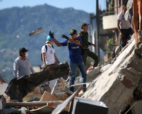 Residents in Pereira dig through the debris of a collapsed building after the quake