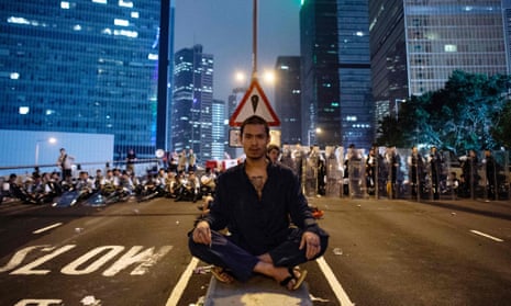 A protester blocks Harcourt Road
