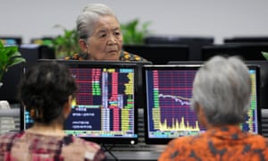 Investors monitor stock prices at a securities company in China’s central Jiangxi province today