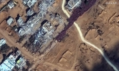 This image provided by Maxar Technologies shows a large crowd of people gathered along Salah al Deen Road attempting to flee south along the evacuation corridor, in southern Gaza.