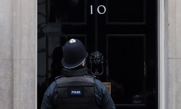 A policeman enters 10 Downing Street in London