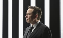 Elon Musk photographed in profile against a black and white striped background