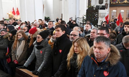 Mourners attend a funeral ceremony for Paweł Adamowicz