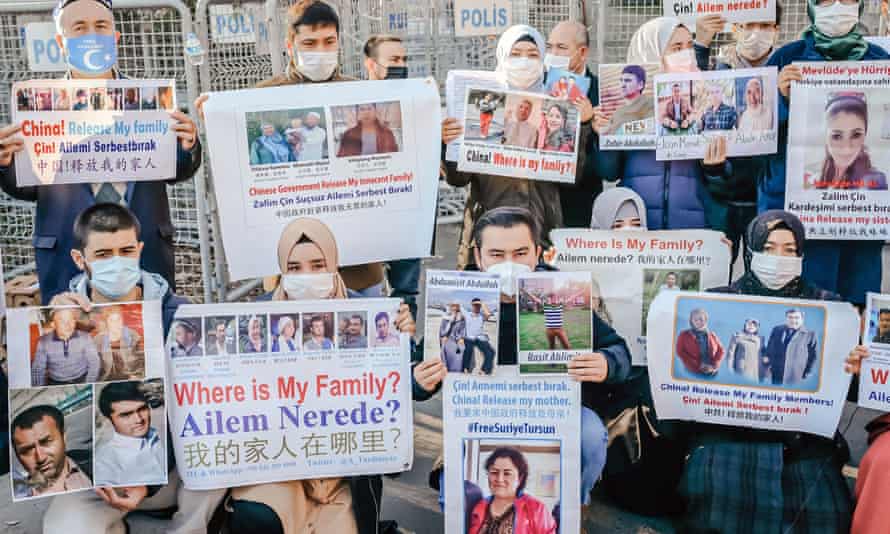 Members of the Muslim Uighur minority hold placards as they demonstrate in front of the Chinese consulate on December 30, 2020, in Istanbul,