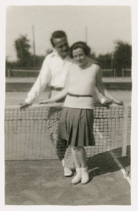black and white photo of a man and a woman on a tennis court