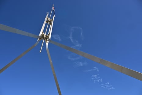 A sky writing plane writes “STOP THE TAX” above Parliament House in Canberra, Tuesday 8 September.