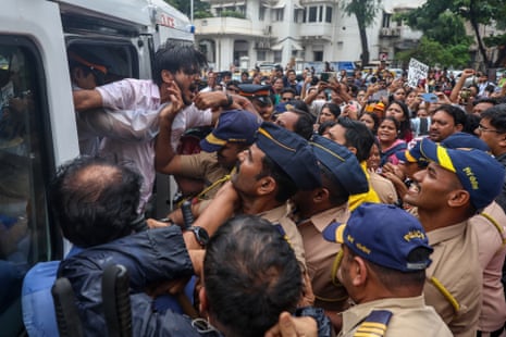 Police detain Cockroach supporters in a large crowd