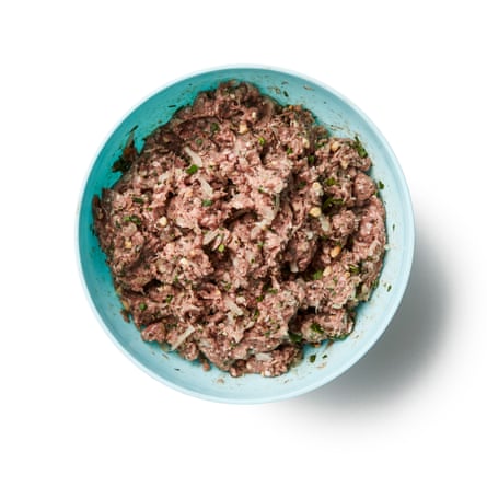 Mixing spices, minced meat, herbs.