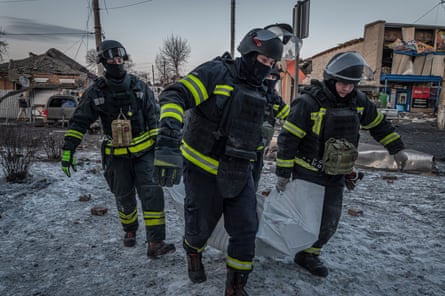 A group of firefighters carrying a body bag
