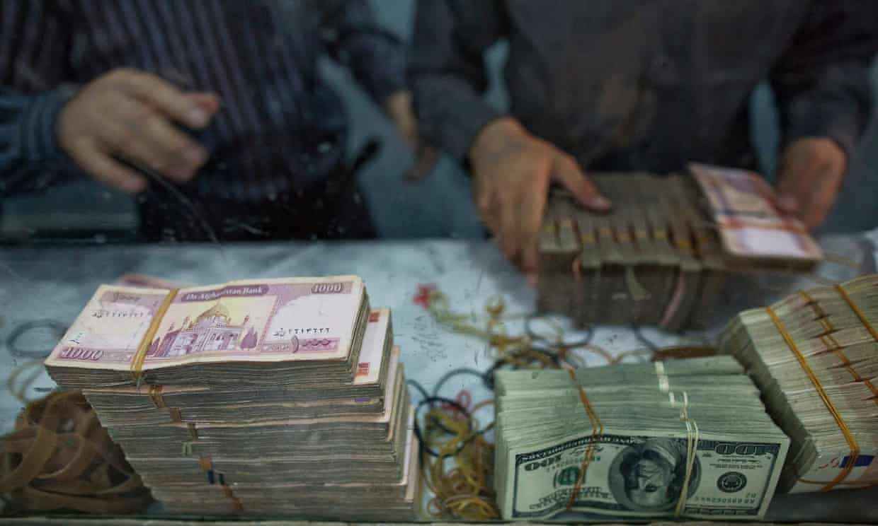 Workers count banknotes of various currencies at the headquarters of the Da Afghanistan Bank in Kabul, Afghanistan.