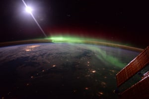 Calgary, CanadaMoonlight reflected in the ISS solar panels as an aurora dances over northern Canada.