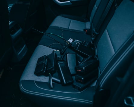 A pile of powerbanks on the seat of a vehicle