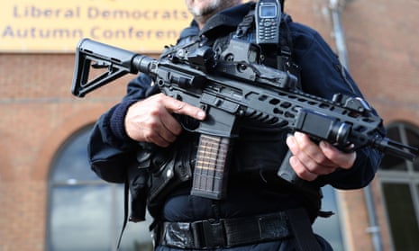 An armed police officer.