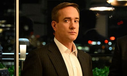 Man wearing black suit and white shirt.