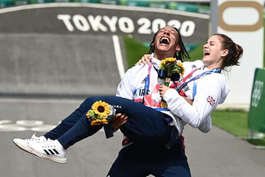 Bethany Shriever (gold) is lifted by Kye Whyte (silver) after both won Olympic medals in Tokyo.