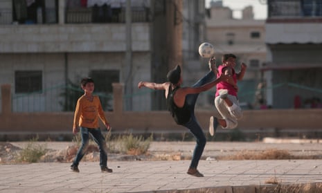 Boys play soccer in Manbij, Syria, where the Syrian Democratic Forces have mostly taken control of the city from Islamic State.