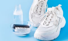 Dirty white sneakers with special tool for cleaning them on blue.<br>Dirty white sneakers with brush and special tool for cleaning them on blue background. Washing concept. Regular care about sneakers.