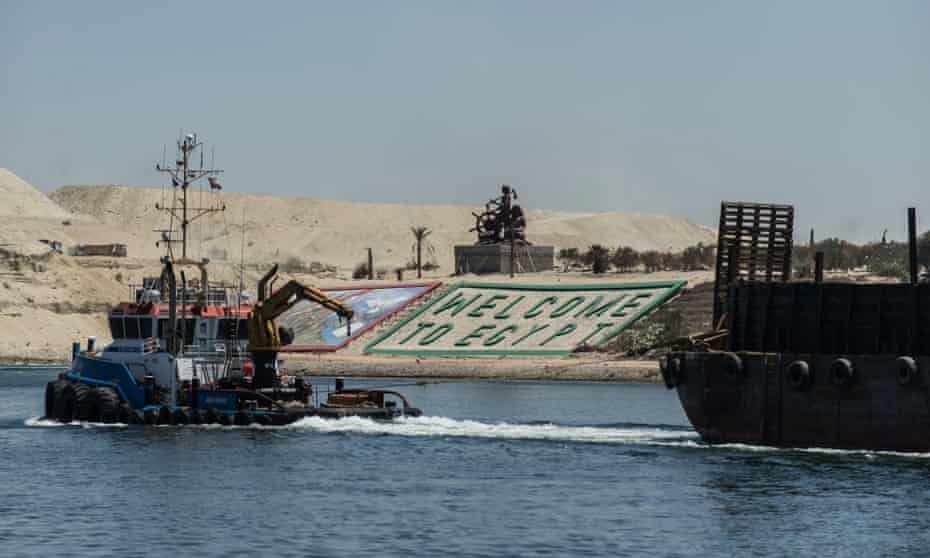 Boats cross through the new Suez canal in Ismailia, Egypt. Officials predict a more than twofold increase in revenues for the canal, from $5.3bn to $13.2bn in 2023.