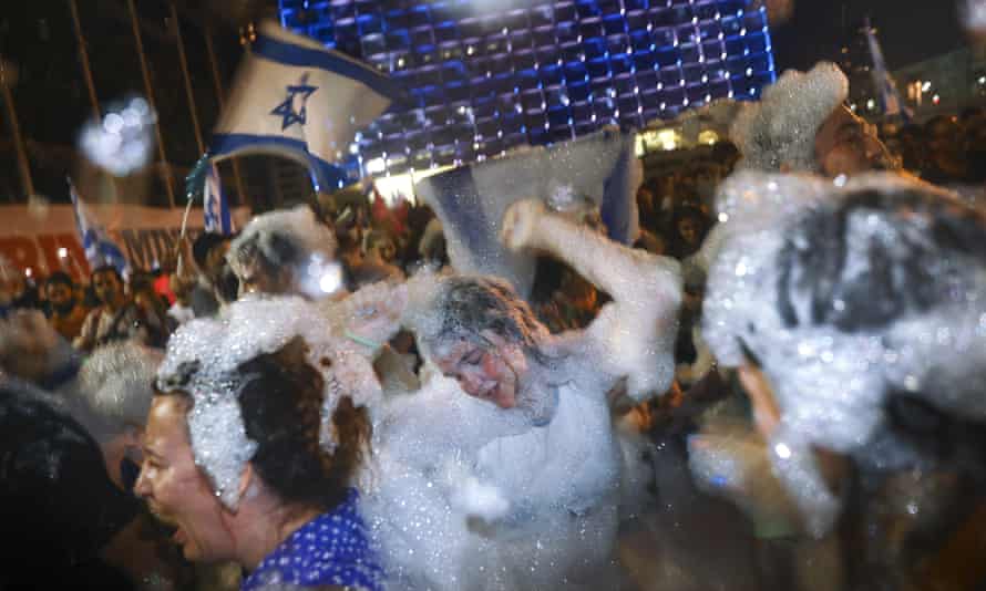 Israelis celebrate the swearing in of the new government in Tel Aviv