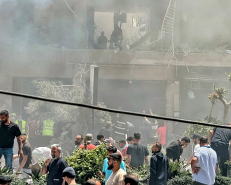 People at the site of an Israeli airstrike in Beirut's southern suburbs on 14 June, 2026.