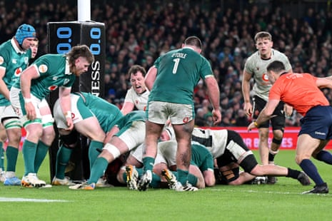 James Botham of Wales (obscured) scores his team's second try