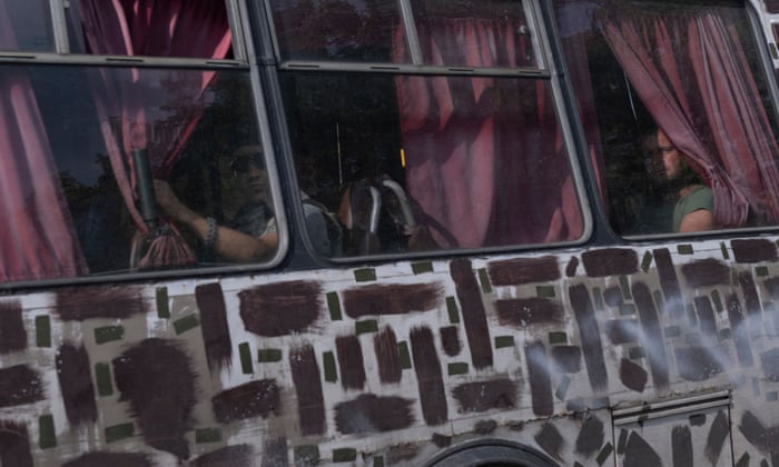 Ukrainian soldiers sit in a bus as they return from the frontline, on the outskirts of Bakhmut