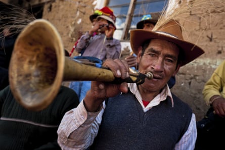 A Peruvian plays a trumpet during the Yawar Fiesta.