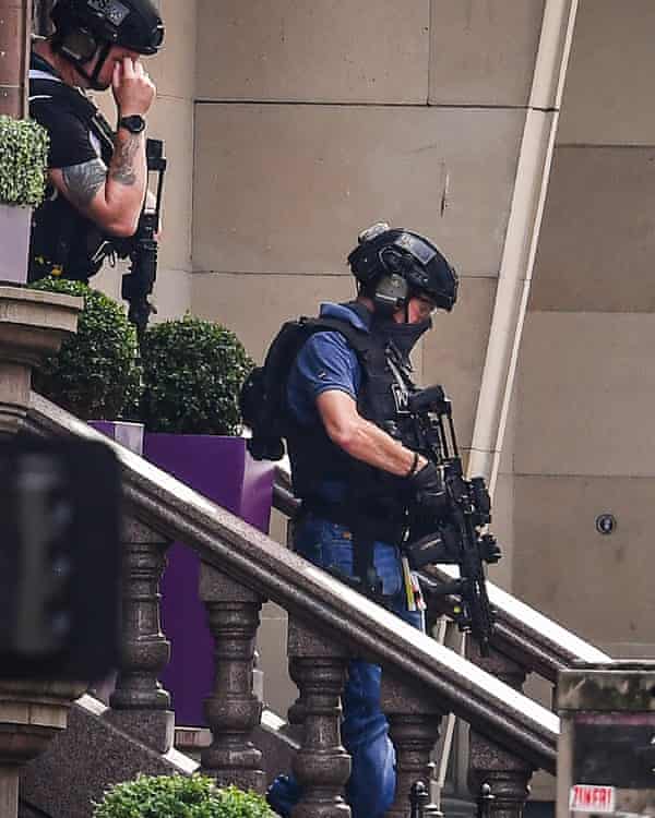 Armed officers leave the Park Inn on 26 June in Glasgow.