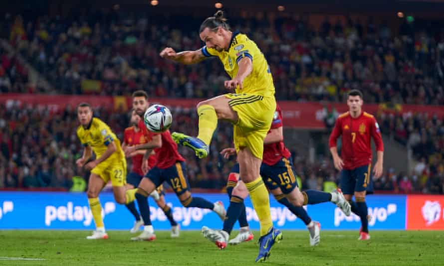 Zlatan Ibrahimovic stretches to control the ball with Spain and Sweden players looking on