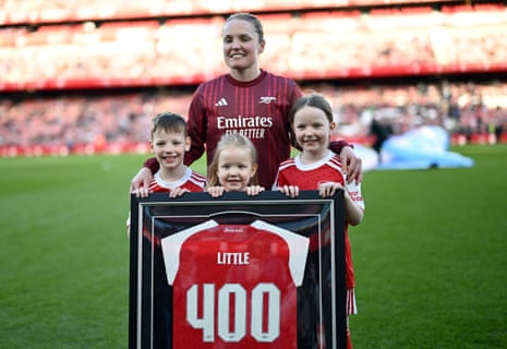 Kim Little is joined by hernieces & nephew after recieving a framed shirt commemorating 400 appearances.