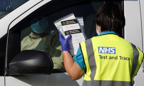 an NHS test and trace worker chats with a driver at a testing centre