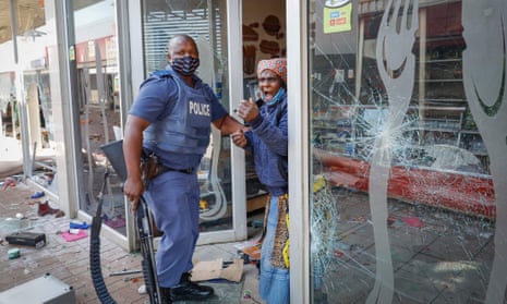 An elderly woman screams as she is arrested by a police member amid looting and vandalism, sparked by the jailing of former president Jacob Zuma, at the Lotsoho Mall east of Johannesburg, South Africa.