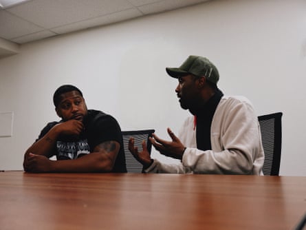 two men in conversation seated at a table